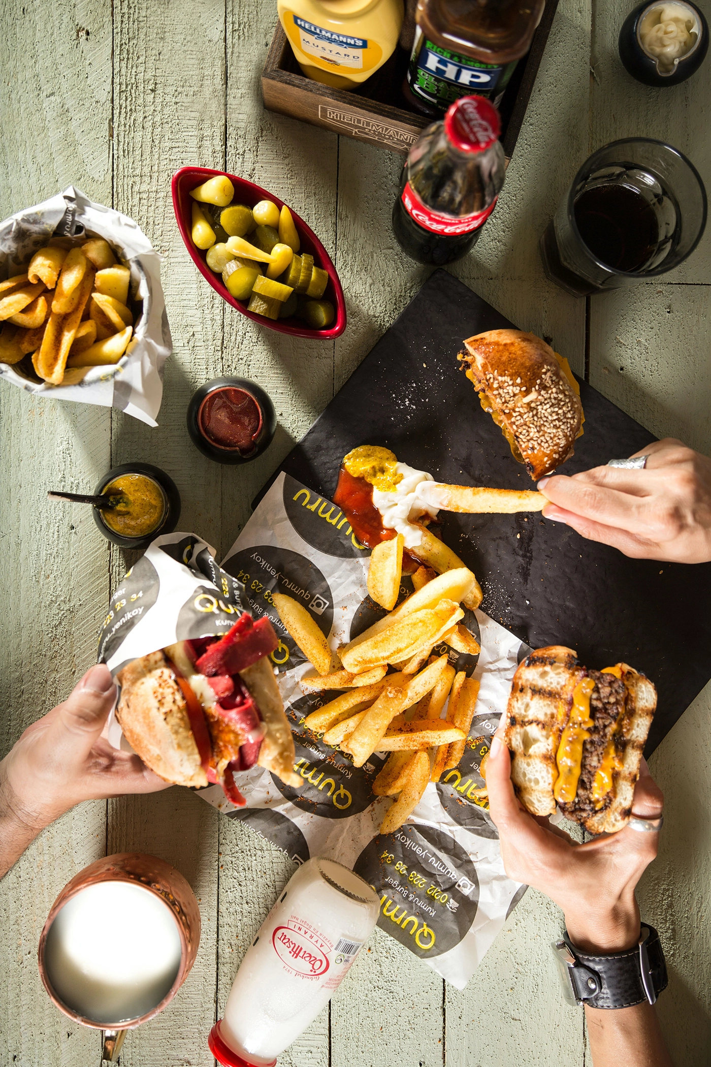 A table full of people eating hamburgers